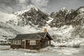 Wooden cottage and snowy mountains Royalty Free Stock Photo