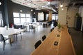 Wooden counter bar in the dining area of a creative business in daylight, no people