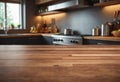 A wooden countertop in a kitchen is positioned next to a window. The countertop is clean and well-maintained, adding a