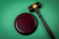 Wooden court gavel on a green background. Law and the concept of fair trial Royalty Free Stock Photo