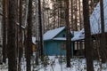 Wooden cozy house in a snowy forest. Nice Christmas atmosphere Royalty Free Stock Photo