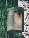 Wooden crafted birdhouse hanging on a tree bark