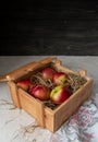 Wooden crate with apples and hay. Rustic still life