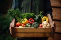 Wooden crate of farm fresh vegetables with cauliflower, tomatoes, zucchini, turnips and colorful sweet bell peppers on a Royalty Free Stock Photo