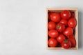 Wooden crate filled with fresh delicious tomatoes on table, top view