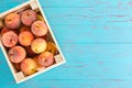 Wooden crate filled with ripe summer peaches Royalty Free Stock Photo