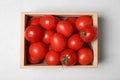 Wooden crate full of fresh delicious tomatoes on table