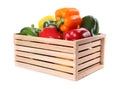 Wooden crate full of fresh ripe colorful bell peppers isolated on white