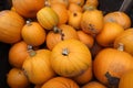 A wooden crate full of various sized Pumpkins