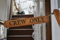 Wooden crew only sign on a ship