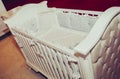 Wooden crib and retro silk bedding and pillows