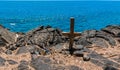 Wooden Cross Above The Rugged Volcanic Shoreline