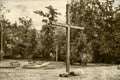 Wooden cross against a dramatic forest. Vintage style