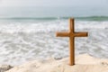 Wooden cross on the beach of the  Sea background. Easter concept. Concept  cross religion symbol in grass over sunset or sunrise s Royalty Free Stock Photo