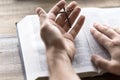 Reading Holy Bible holding a wooden cross in hand Royalty Free Stock Photo