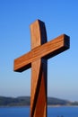 Shiny wooden cross in blue sky Easter symbol Royalty Free Stock Photo