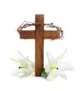 Wooden cross, crown of thorns and blossom lilies Royalty Free Stock Photo