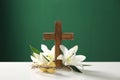 Wooden cross, crown of thorns, Easter eggs and blossom lilies on table Royalty Free Stock Photo