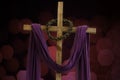 Wooden cross, crown of thorns and purple fabric Royalty Free Stock Photo