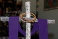 Wooden cross, crown of thorns and purple fabric Royalty Free Stock Photo