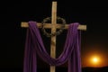 Wooden cross, crown of thorns and purple fabric Royalty Free Stock Photo