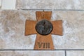 Wooden cross with the face of Jesus Christ and latin number 8 hanging on the wall in the Dominus Flevit Church on the Mount Eleon