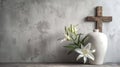 Wooden cross, funeral urn and lily flowers branch on concrete stone background. Funeral, .cremation, condolence, religious