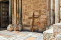 Wooden cross lean against the wall of the Holy Sepulchre church Royalty Free Stock Photo