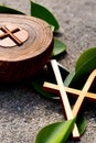 a wooden cross and olive leaves on the ground generated by ai