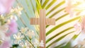 Wooden cross with palm leaf and tender pink spring flowers on gradient background Royalty Free Stock Photo