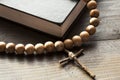 Wooden Christian Cross next the Closed Bible Royalty Free Stock Photo