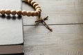 Wooden Christian Cross next the Closed Bible Royalty Free Stock Photo