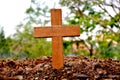 A wooden cross rose to the ground with natural background,