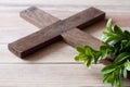 Wooden cross with sprigs of boxwood, easter symbol of life and immortality, concept