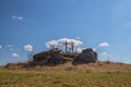 Wooden cross on a stone hilltop