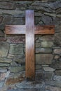 Wooden cross on the stone wall Royalty Free Stock Photo