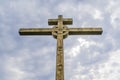 A wooden cross on top of a hill. Orthodox white cross glows on the top of the hill on the background of blue sky Royalty Free Stock Photo