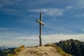 Wooden cross on top of a hill with rocky mountains in the background in Austria Royalty Free Stock Photo