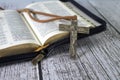 Wooden cross on top of an open bible and wood table. Copy space Royalty Free Stock Photo