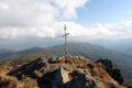 Wooden cross on top of a rocky hill Royalty Free Stock Photo