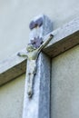 Wooden crucifix on the wall closeup. Image of Jesus. Unfocused distant plan Royalty Free Stock Photo