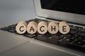 Wooden cube block on computer keyboard with text CACHE Royalty Free Stock Photo