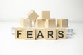 wooden cube block with fears business word on table background