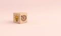 Wooden cube block with icon target and light bulb on pink background. Concept of business strategy Royalty Free Stock Photo
