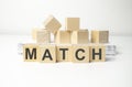 wooden cube block with match business word on table background