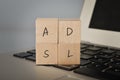 Wooden cube block with text ADSL. ADSL stands for \