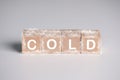 wooden cube block with text COLD and ice crystal. temperature, weather and environment concept Royalty Free Stock Photo