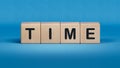 wooden cube block with time business word.