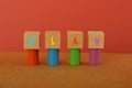 Wooden cube blocks with text PLAY. Playtime for kids