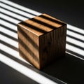 Wooden cube illuminated by striking light streaks from blinds creating dramatic shadows Royalty Free Stock Photo